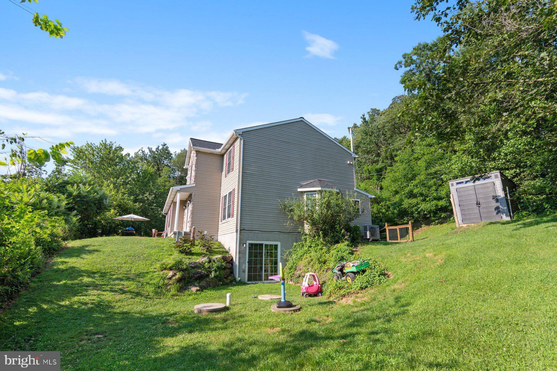 1903 Hain Road New Freedom, PA 17349 - Photo 36 of 40 a view of a backyard with potted plants and a large tree