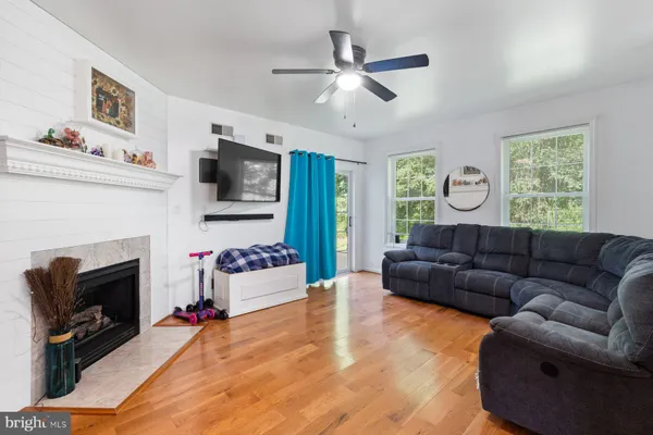 a living room with furniture fireplace and flat screen tv