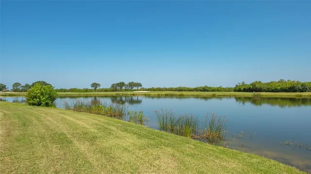 a view of a lake with a building in the background