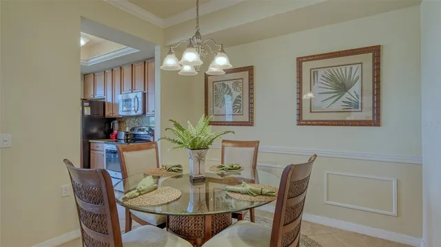 a view of a dining room with furniture and chandelier