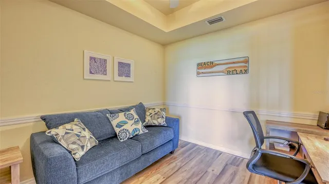 a living room with couch and a wooden floor