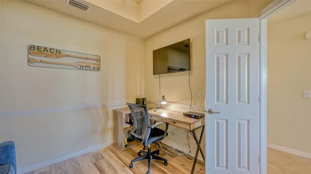 a view of a workspace with furniture and wooden floor