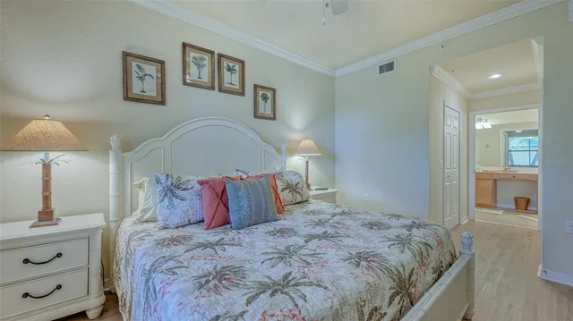 a bedroom with a large bed and a chandelier