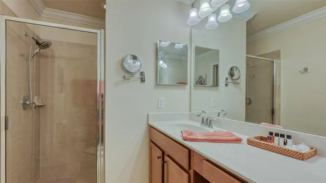 a bathroom with a sink vanity and shower