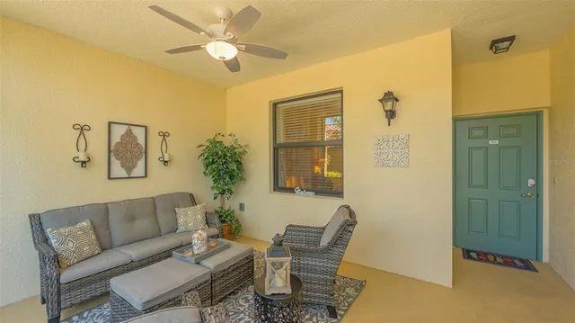 a living room with furniture and a potted plant