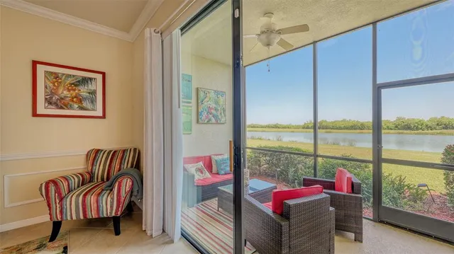 a living room with furniture and a floor to ceiling window