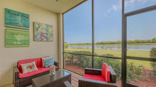 a living room with furniture and a floor to ceiling window