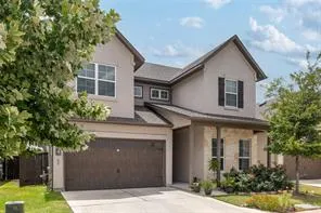 a front view of a house with a yard garage and outdoor seating