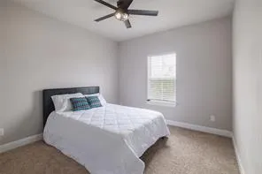 a bedroom with a bed and window