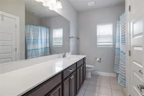 a large bed sitting in a bedroom next to a window