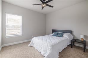 601 C-Bar Ranch Trail, Unit 51 Cedar Park, TX 78613 - Photo 26 of 33 Bedroom featuring light colored carpet and a ceiling fan