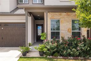 601 C-Bar Ranch Trail, Unit 51 Cedar Park, TX 78613 - Photo 3 of 33 Entrance to property with a garage, stone siding, driveway, and covered porch