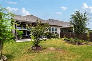 a view of a house with backyard and sitting area