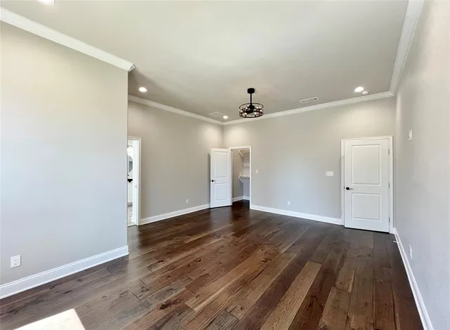 a view of an empty room and wooden floor