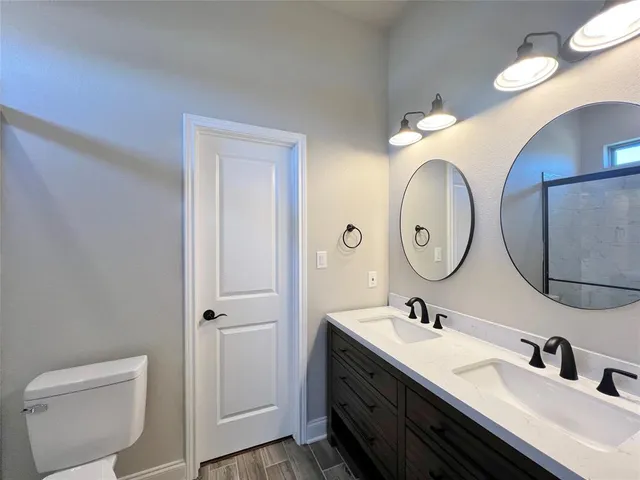 a bathroom with 2 sink and a mirror
