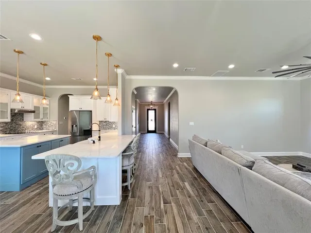 a living room with hard wood flooring and furniture