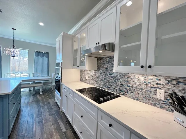 a kitchen with a sink stove and wooden cabinets