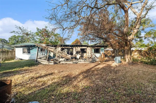 a view of a house with a yard covered in snow