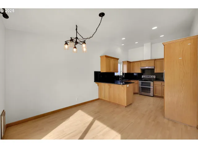 a kitchen that has a lot of cabinets and appliances