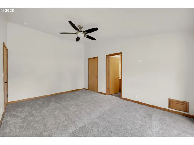 a view of a livingroom with a ceiling fan and window
