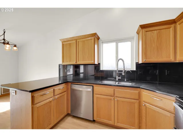 a kitchen with cabinets a sink and dishwasher