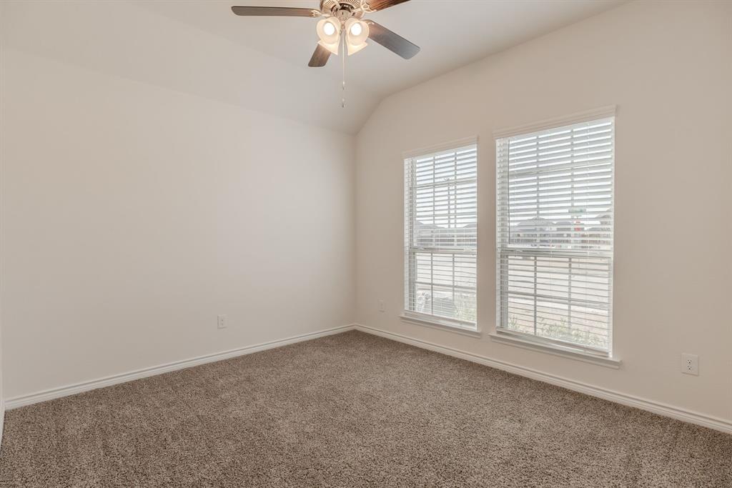 2902 Trusting Way Aubrey, TX 76227 - Photo 21 of 38 Carpeted interior space featuring twin windows with horizontal blinds, a vaulted ceiling, a ceiling fan with integrated lighting, and white baseboards