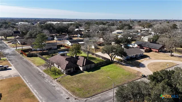 an aerial view of residential houses with outdoor space