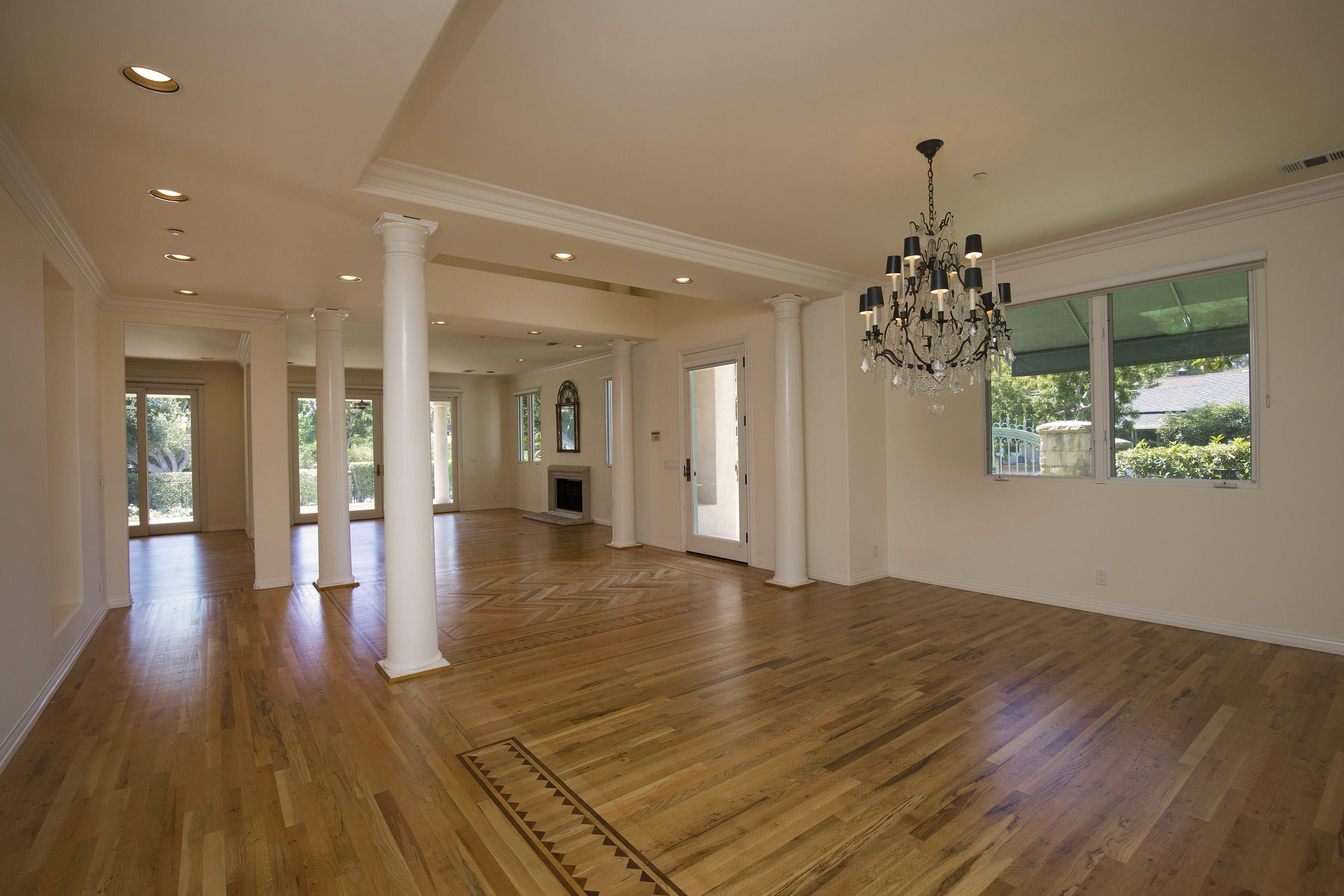 1138 Hill Road Montecito, CA 93108 - Photo 3 of 15 a view of a hallway with wooden floor and a chandelier