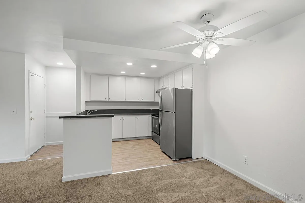 6006 Rancho Mission Road San Diego, CA 92108 - Photo 12 of 32 a view of a kitchen with a sink and a refrigerator