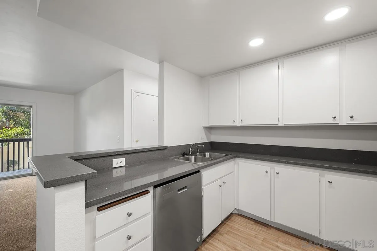6006 Rancho Mission Road San Diego, CA 92108 - Photo 15 of 32 a kitchen with granite countertop a sink and cabinets
