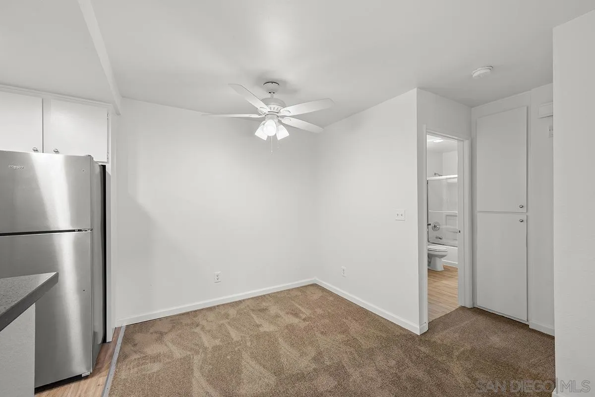 6006 Rancho Mission Road San Diego, CA 92108 - Photo 19 of 32 a view of an empty room with a kitchen