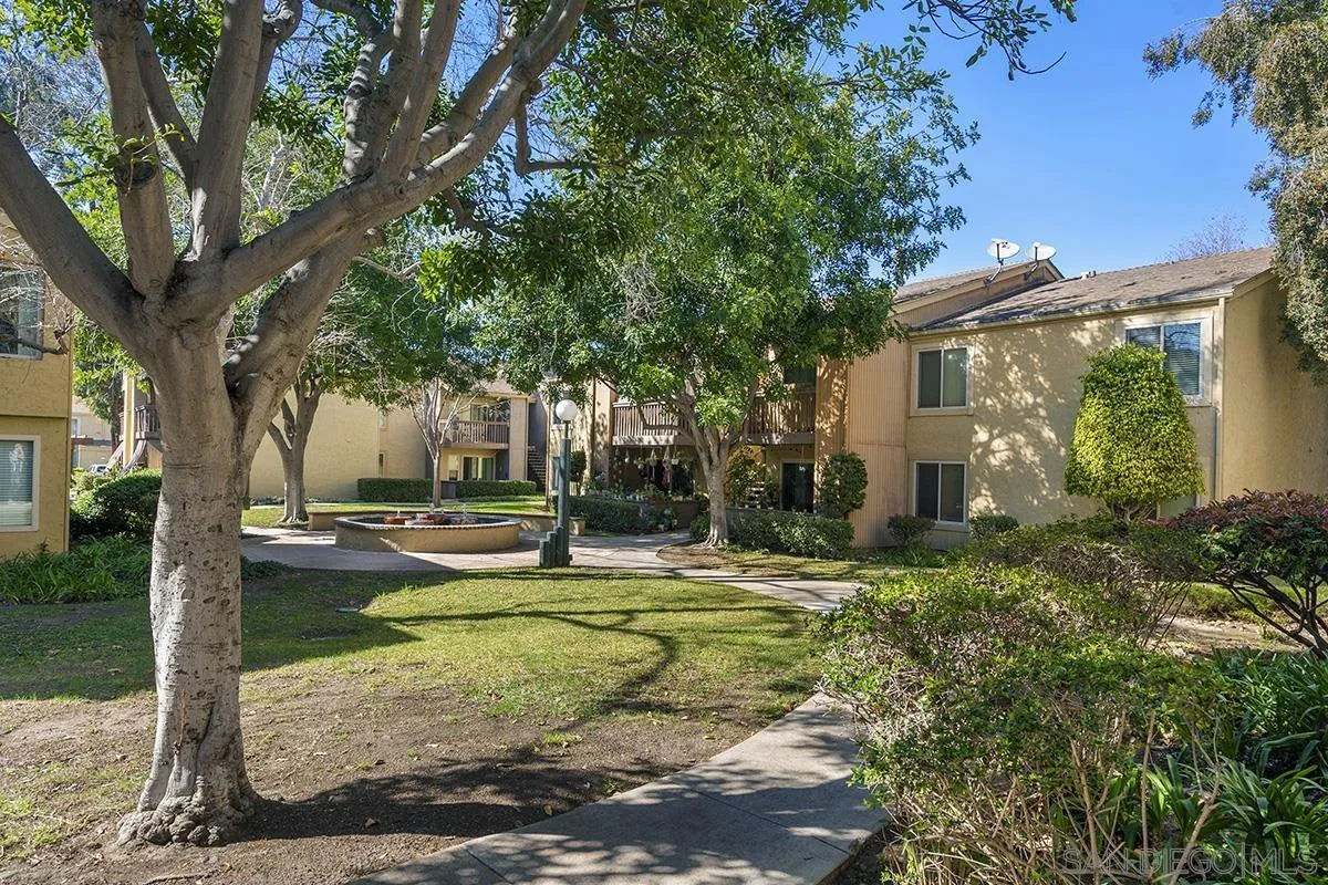 6006 Rancho Mission Road San Diego, CA 92108 - Photo 23 of 32 a view of a house with backyard and a tree