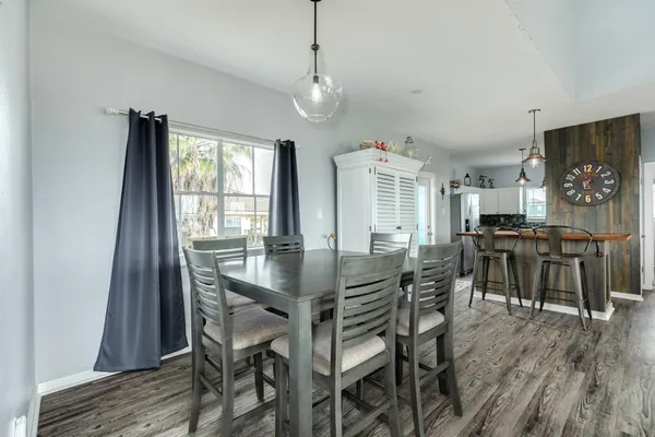 a kitchen with stainless steel appliances a stove a chimney a sink and cabinets