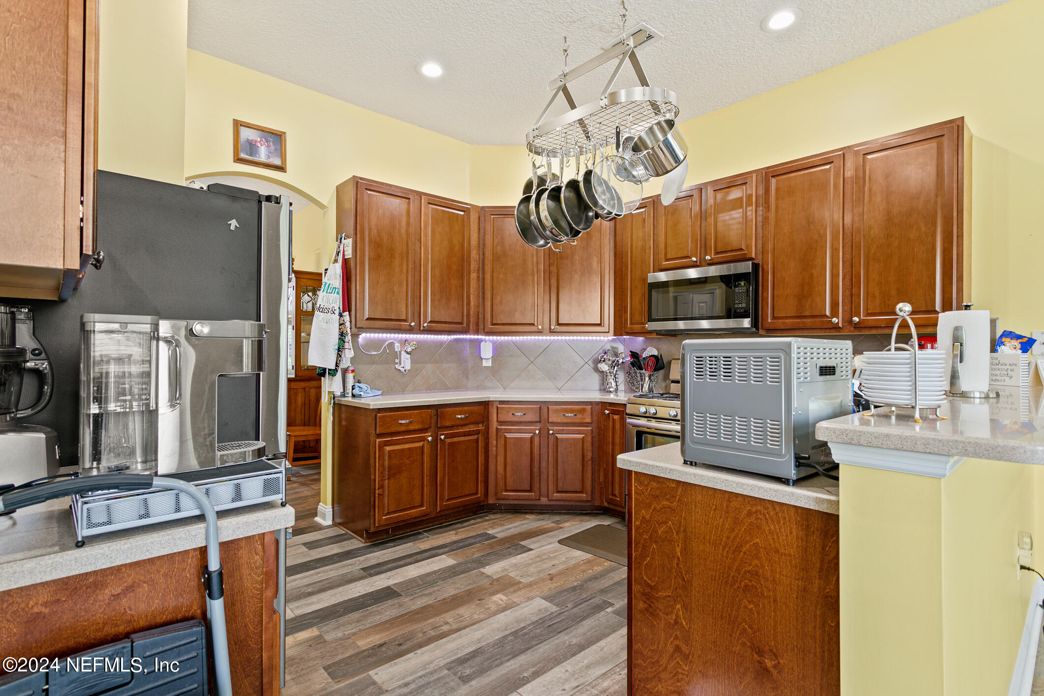 1658 Lockend Road Jacksonville, FL 32221 - Photo 19 of 54 a kitchen with kitchen island granite countertop a sink appliances cabinets and a counter top space