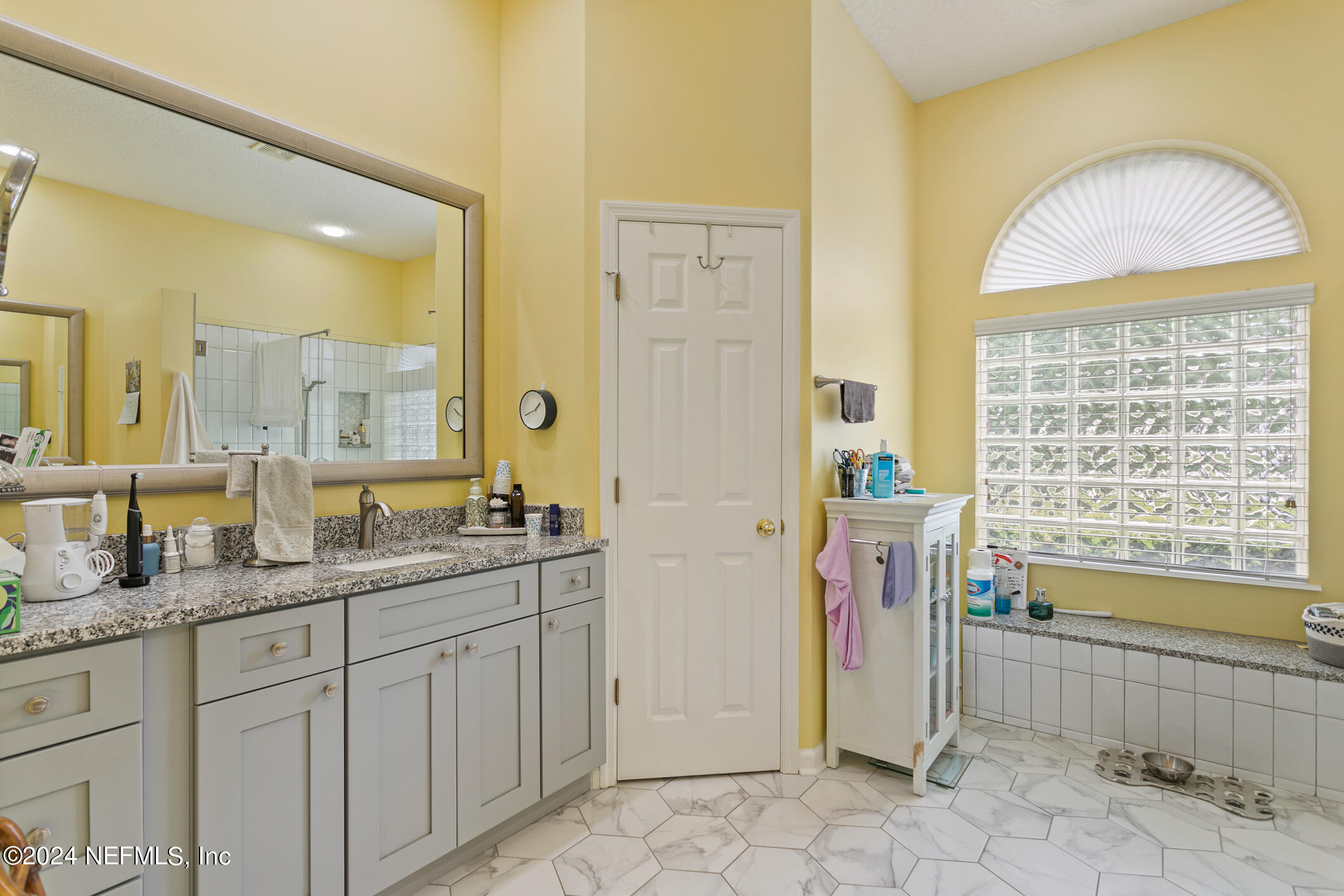 1658 Lockend Road Jacksonville, FL 32221 - Photo 30 of 54 a spacious bathroom with a double vanity sink a mirror and a shower