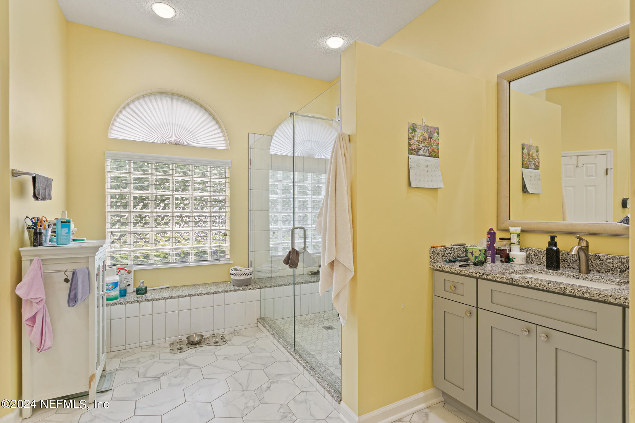 1658 Lockend Road Jacksonville, FL 32221 - Photo 32 of 54 a bathroom with a granite countertop sink a toilet and shower