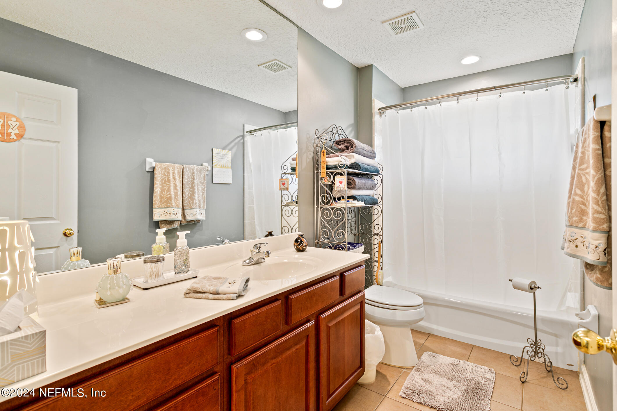 1658 Lockend Road Jacksonville, FL 32221 - Photo 34 of 54 a bathroom with a double vanity sink toilet and a mirror