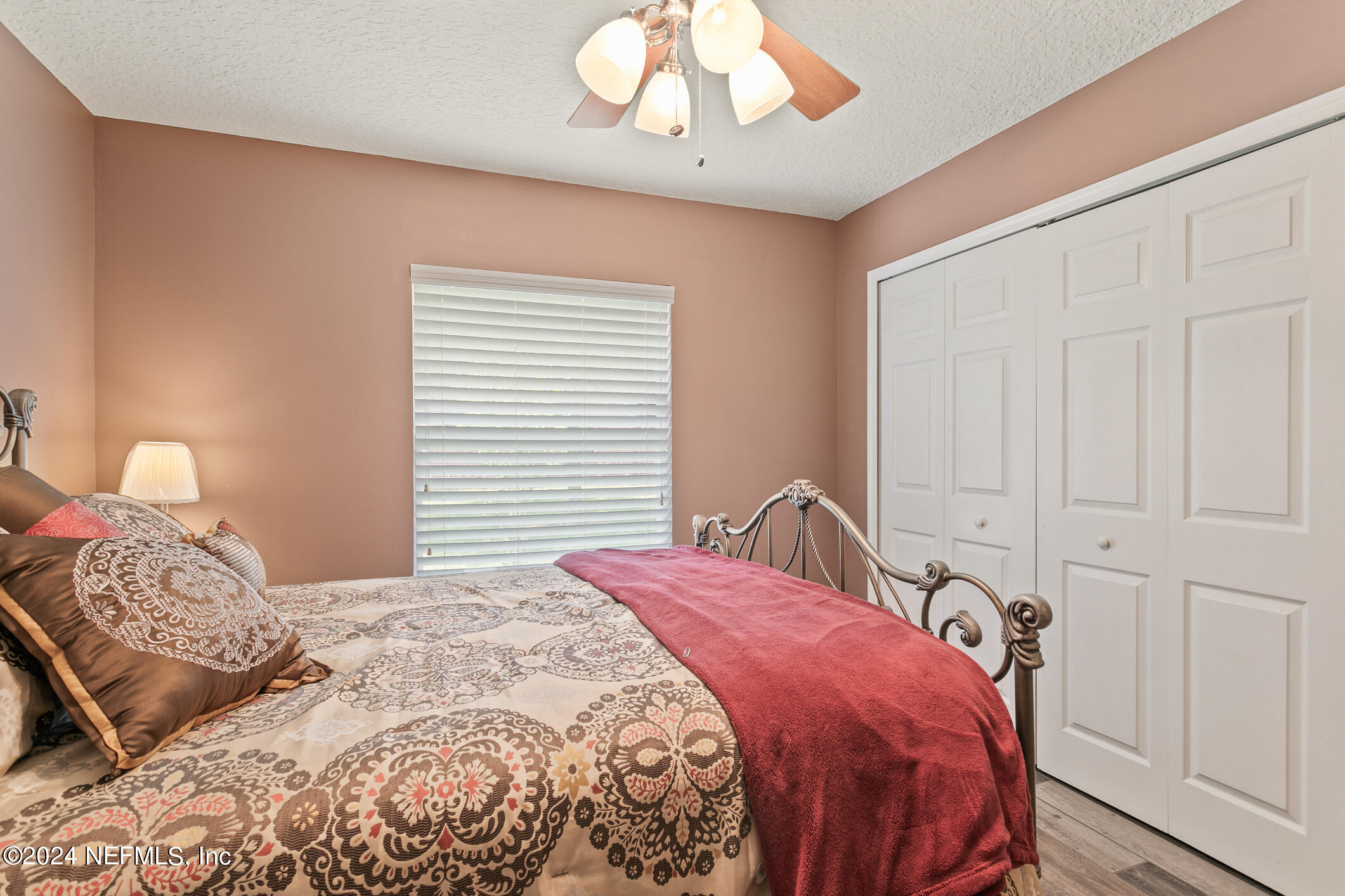 1658 Lockend Road Jacksonville, FL 32221 - Photo 35 of 54 a bedroom with a bed and a chandelier