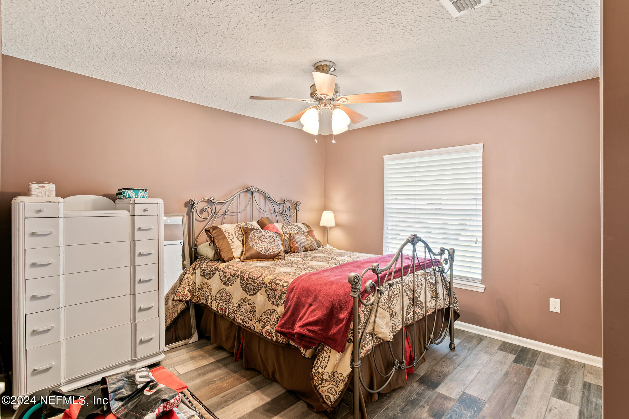 1658 Lockend Road Jacksonville, FL 32221 - Photo 36 of 54 a bedroom with a bed and a chandelier