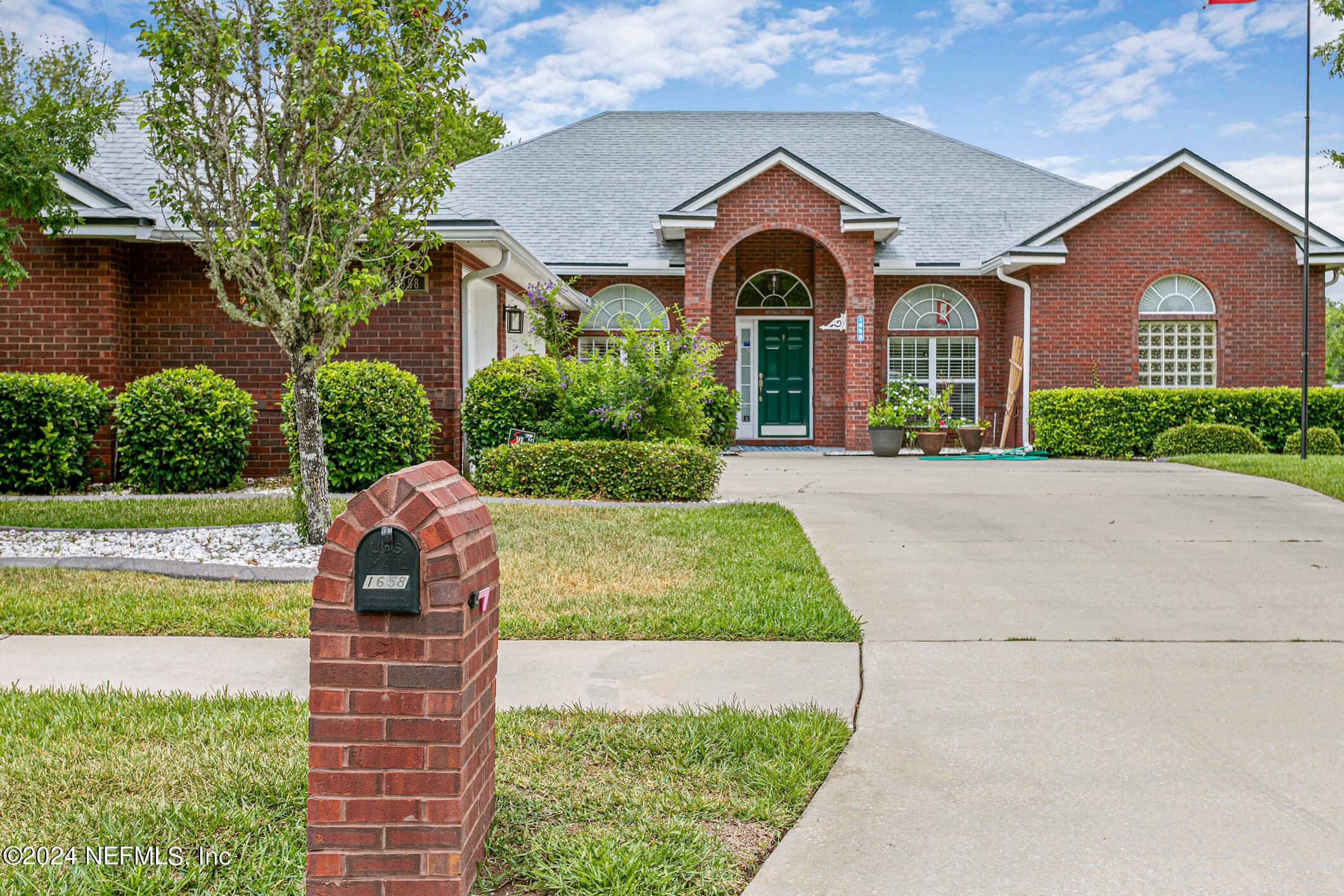 1658 Lockend Road Jacksonville, FL 32221 - Photo 4 of 54 a front view of a house with a yard