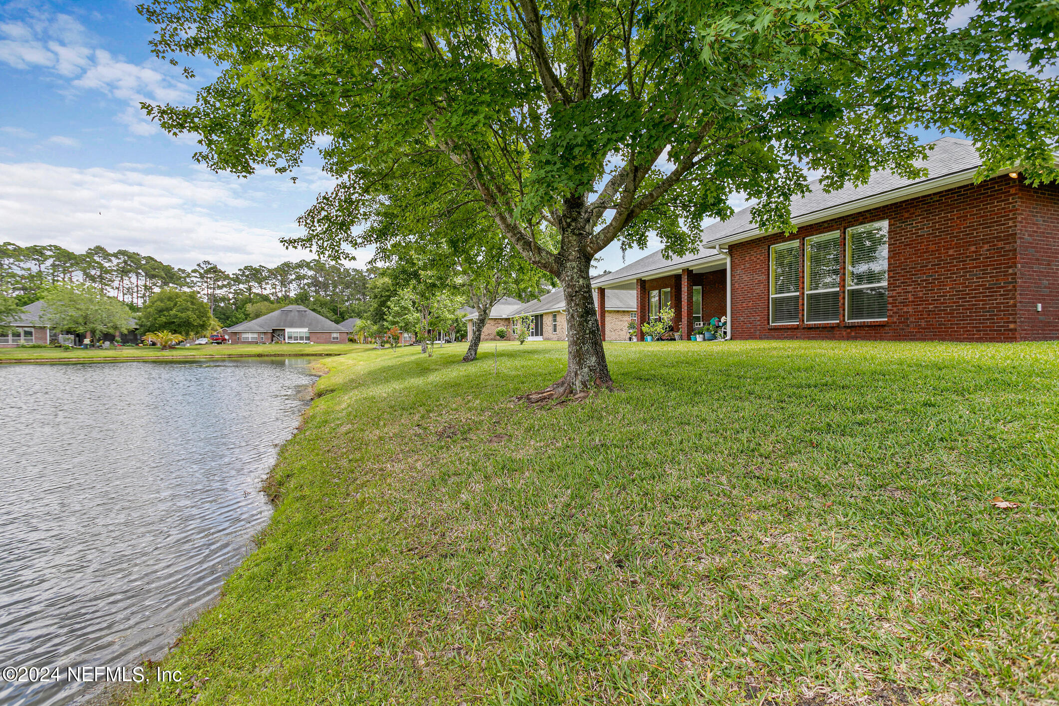 1658 Lockend Road Jacksonville, FL 32221 - Photo 42 of 54 a view of a house with a yard and a large tree