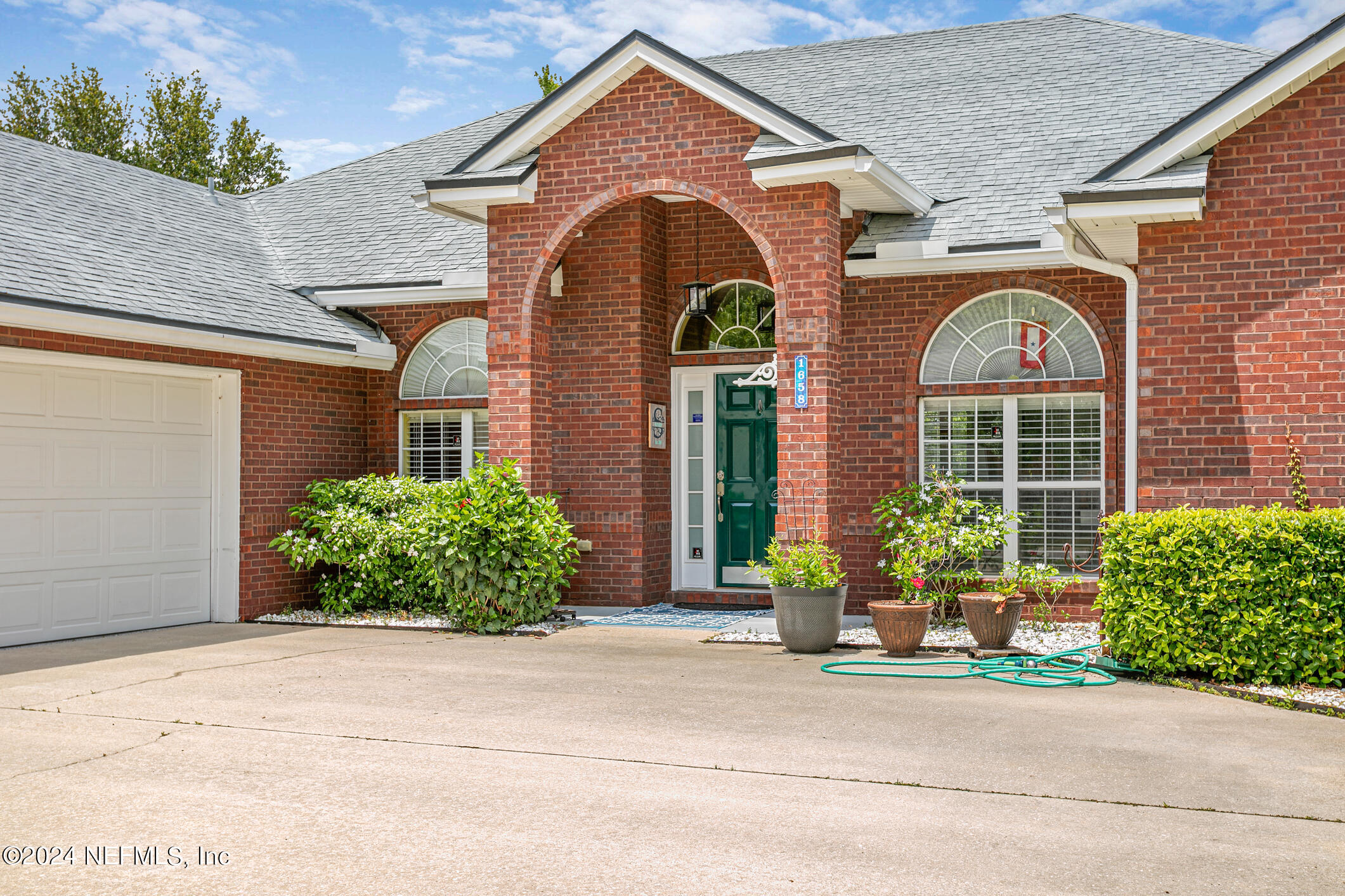 1658 Lockend Road Jacksonville, FL 32221 - Photo 5 of 54 a front view of a house with garden