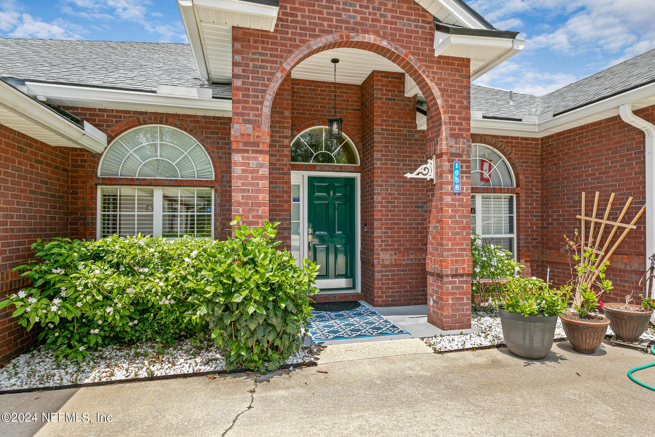 1658 Lockend Road Jacksonville, FL 32221 - Photo 6 of 54 a front view of a house with a garden