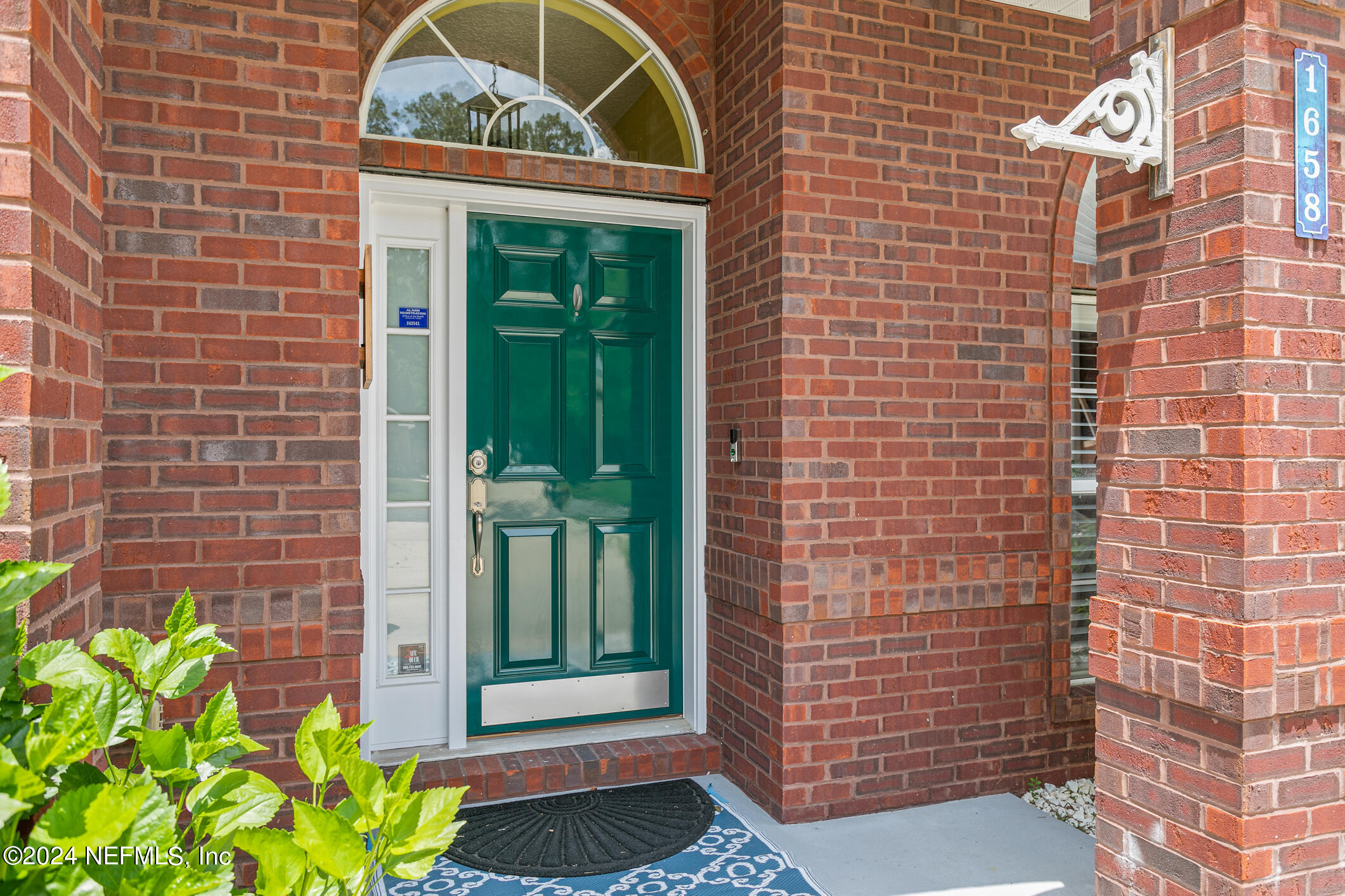 1658 Lockend Road Jacksonville, FL 32221 - Photo 7 of 54 a view of a brick house with a potted plant