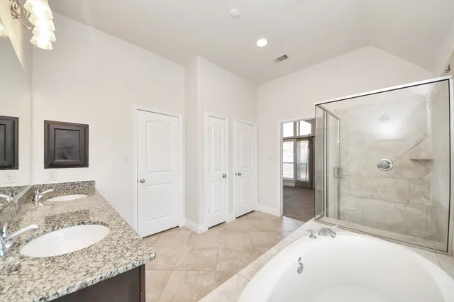 a view of a backyard with potted plants and large tree