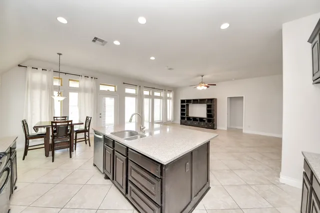 an empty room with windows and fireplace