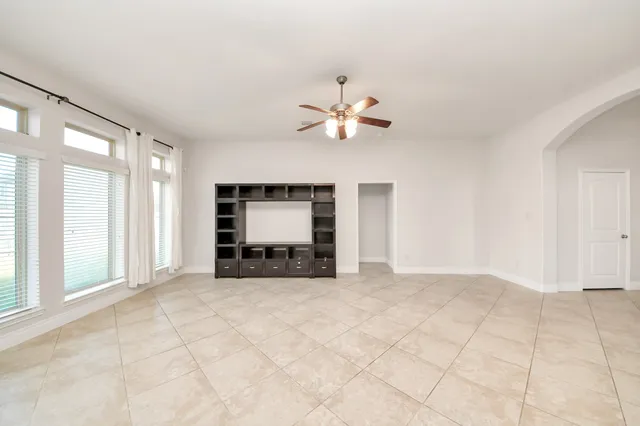 a spacious bathroom with a tub sink shower and mirror