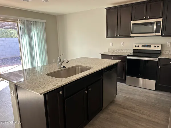 a kitchen with a sink stove and microwave