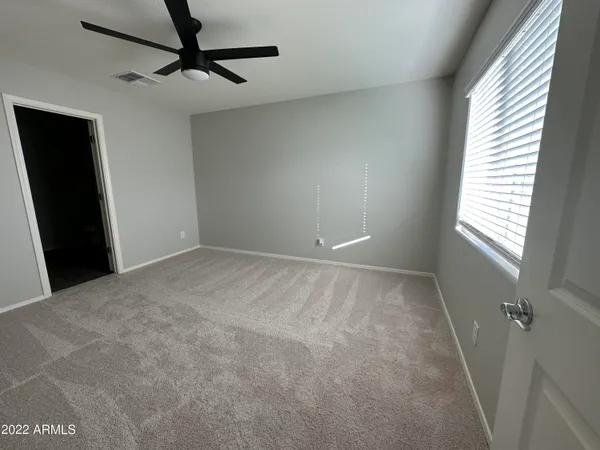 a view of an empty room and a window