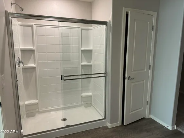 a bathroom with a glass shower door